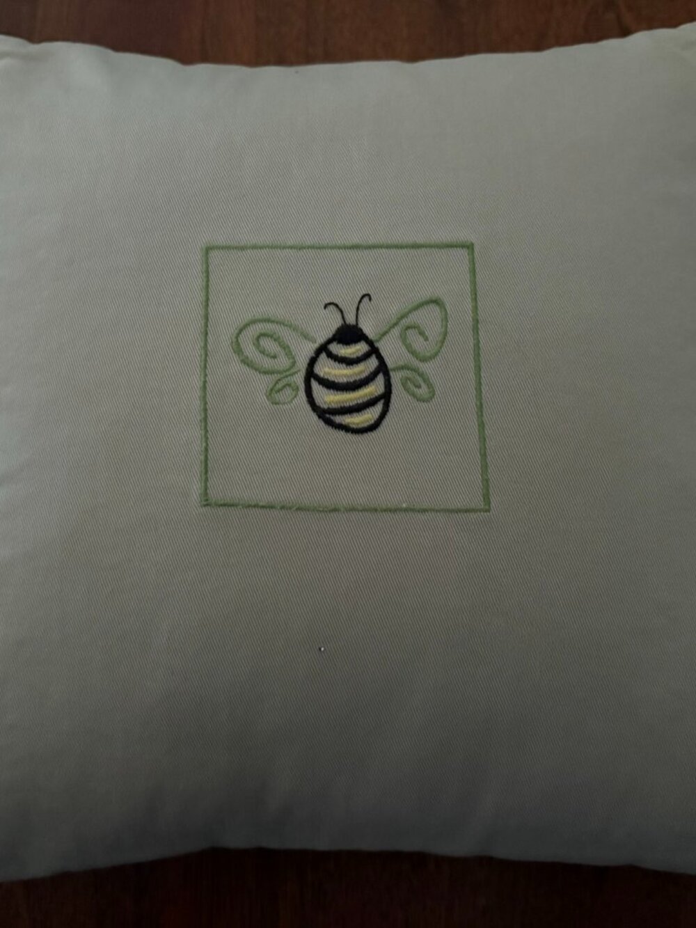 Decorative beige pillow with embroidered bumblebee, 12'x12" inches